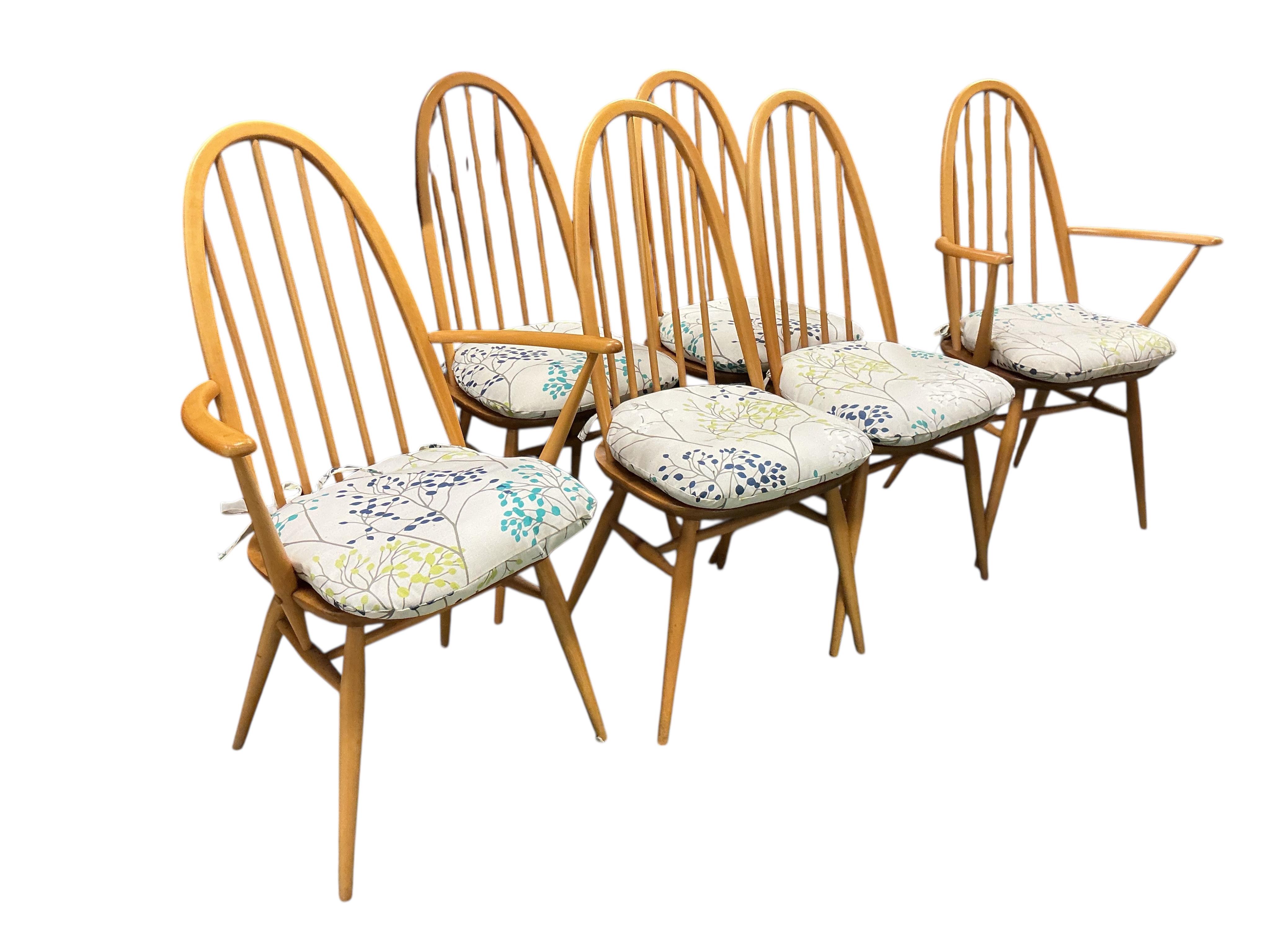 An Ercol elm and beech rectangular dining table, width 150cm, 75cm, height 72cm, together with a set of six Ercol elm and beech comb back dining chairs, two with arms and an Ercol style sideboard